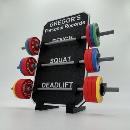 Display stand with weight plates labeled for different exercises on a white background