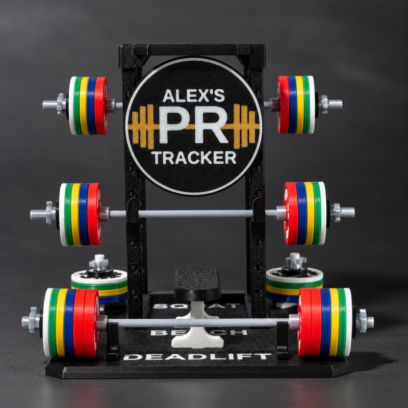 A black metal deadlift rack with colorful weight plates in red, yellow, green, and blue. The center features a circular sign reading 'ALEX'S PR TRACKER'.